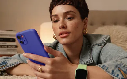 Person reading about fiat money on a smartphone
