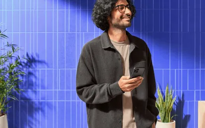 Person smiling while checking the price of Ethereum on their phone