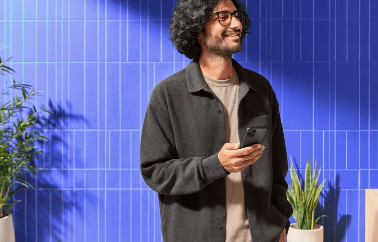 Person smiling while checking the price of Ethereum on their phone