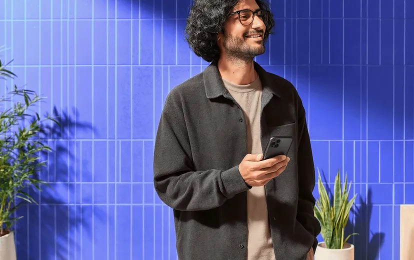 Person smiling while checking the price of Ethereum on their phone